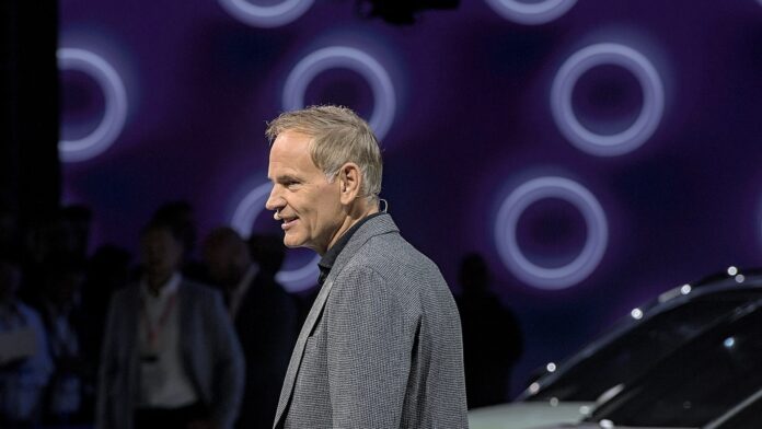 Volkswagen CEO Oliver Blume speaking on stage