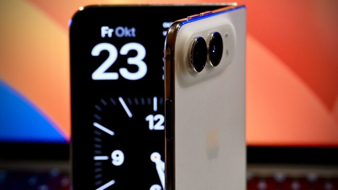 iphone-duo-half-open A half-open iPhone Duo foldable phone in front of a laptop