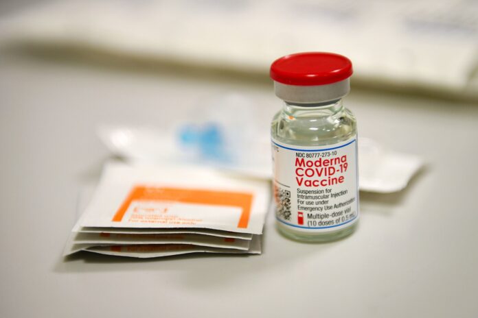 moderna-mrna-vaccine-vial A vial of Moderna's mRNA COVID-19 vaccine on a table